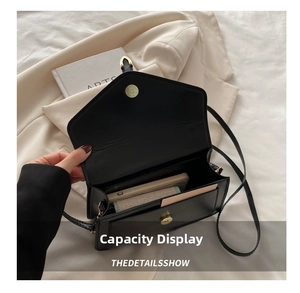 Interior view showing the storage capacity of the black leather crossbody square bag