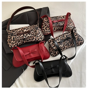 Detailed overhead view of fashion baguette bags with bow accents and leopard patterns