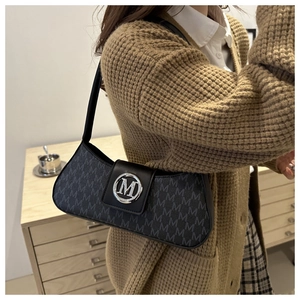 Detail of dark grey underarm bag with M-letter monogram print and silver metal ring buckle
