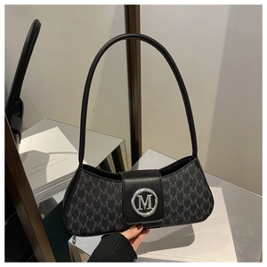 Detail of grey M-letter monogram fabric and silver metallic buckle on a shoulder bag
