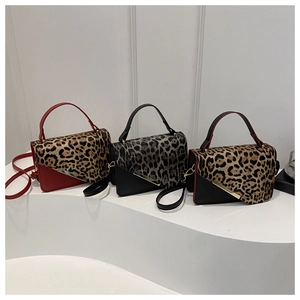 Close-up of leopard print textures and metal trim on fashion crossbody handbags