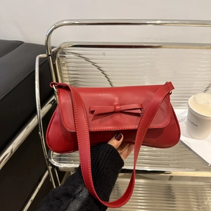 Chic red leather underarm bag featuring a 3D bow and elegant long oval shape silhouette