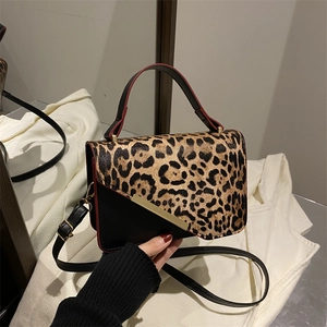 Leopard print patchwork shoulder bag with gold hardware and stylish red edge details