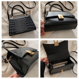 Detail views of black crocodile pattern handbag showing interior space and gold hardware