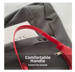 Close-up of red woven crescent bag featuring metal zipper and premium oil-edge finish