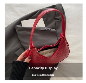 Detailed view of the red crescent bag open to reveal a spacious interior compartment