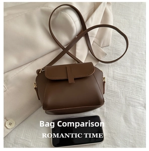 Brown crossbody shell bag size comparison with a smartphone for dimension reference