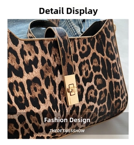Detailed close-up of leopard print shoulder bag featuring gold rectangular twist lock