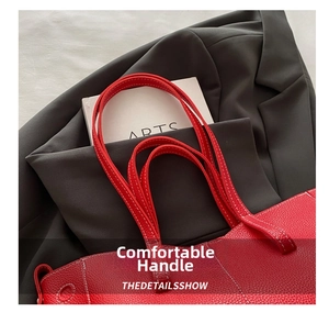 Close-up of red lychee grain PU leather tote bag with sturdy handles and neat stitching