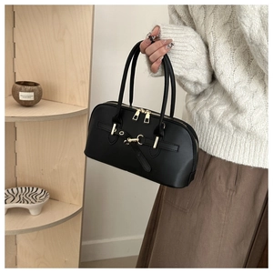 Detail of vintage black leather bowling bag with golden hardware and twin zipper closure