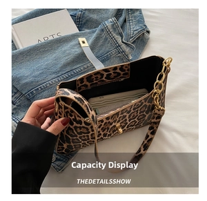Interior capacity display of leopard print bag showing space for phone and wallet