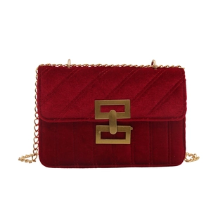 Deep red velvet crossbody bag with gold chain strap and elegant quilted pattern