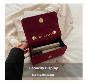 Macro view of burgundy velvet bag interior showing capacity for smartphone and cardholder