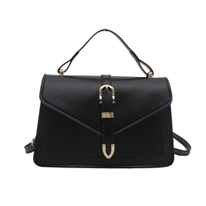 Black leather handbag with gold horseshoe buckle and adjustable shoulder strap