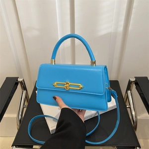 Blue glossy leather underarm bag with gold metal clasp and adjustable shoulder strap