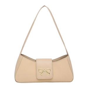 Minimalist beige baguette bag with a stylish golden bow clasp on the front flap