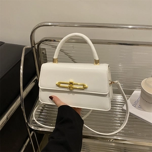 Minimalist white leather handbag with gold bar clasp and top handle for women