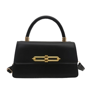 Minimalist black matte leather trapezoid handbag with gold clasp and top handle
