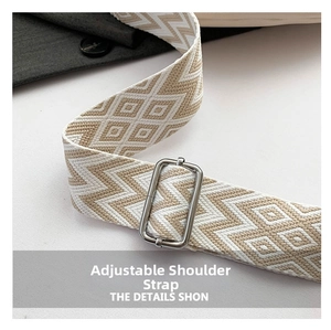 Detail of adjustable geometric woven shoulder strap with silver metal buckle on a grey blazer