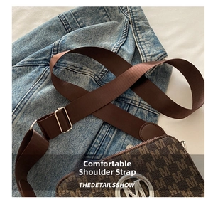 Close-up of the vintage monogram pattern bag with wide nylon strap and M metal logo