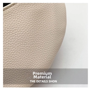 Detail of premium beige lychee grain leather with high-quality stitching on crossbody bag