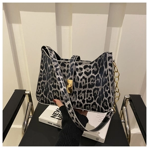 Detail of grey leopard print shoulder bag featuring a gold square twist lock and chain strap