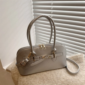 Retro shell-style crossbody bag in silver-grey with gold hardware and top handles