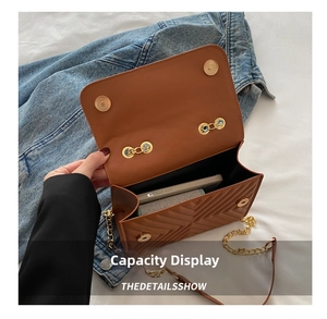 Internal view of brown V-quilted crossbody bag showing spacious capacity for phone and cards
