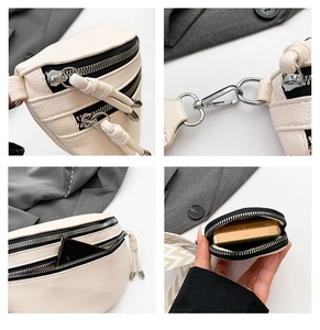Detailed close-up of cream lychee texture leather with silver zippers and woven strap