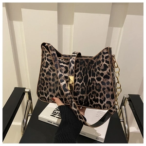 Detail of leopard print handbag featuring a gold twist lock and metallic chain accents