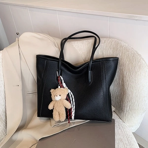 Classic black pebbled leather tote bag with a cute bear charm for office commute