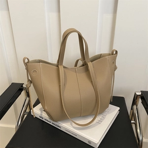 Litchi pattern leather tote bag with contrast stitching and dual handles in apricot color