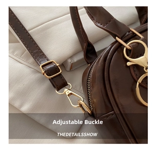 Close-up of deep brown PU leather bag with golden adjustable buckle and neat stitching