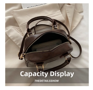 Top-down detail shot showing the spacious interior and zipper of the brown PU handbag