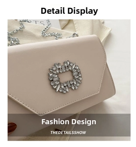Macro detail of high-quality leather flap bag with elegant crystal square buckle and chain