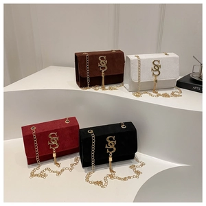 Detail of four matte suede chain bags in brown, white, burgundy, and black colors