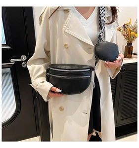 Fashionable black leather chest bag set with wide woven strap on a female model