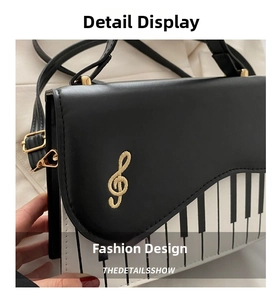 Close-up of piano key print and gold musical note embroidery on crossbody bag