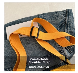 Detail showing bright yellow woven shoulder strap with black adjustable plastic buckle