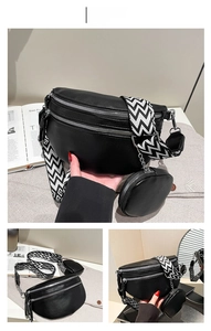 Detail of black pebbled leather crossbody bag with wide woven strap and round coin purse
