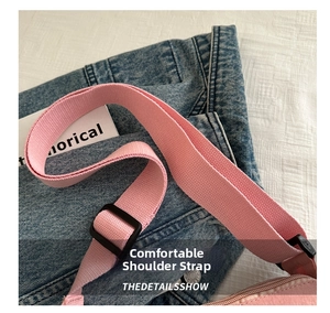 Detail of pink knitted wide shoulder strap with black adjustable buckle for crossbody bag