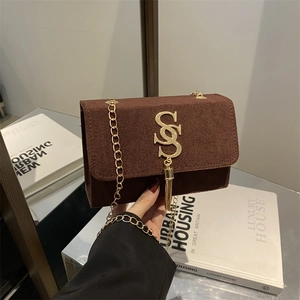 Brown suede shoulder bag with gold chain strap and metallic tassel detail on front cover