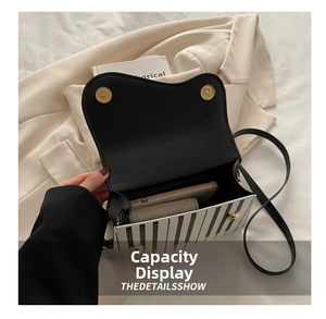 Interior view showing the storage capacity of the piano-themed crossbody bag