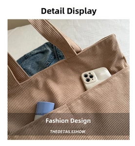 Detailed view of khaki corduroy tote bag showing side pockets for phone and makeup storage