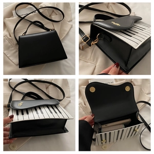 Detail view of piano key handbag interior and golden musical note clasp on leather flap