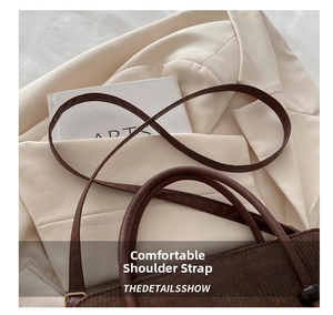 Detail of vintage corduroy tote bag with smooth brown leather strap and handle craftsmanship