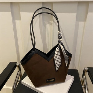 Brown suede tote bag with black leather trim and decorative silk scarf on handle