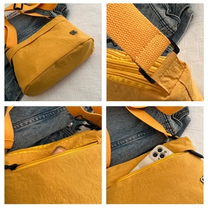 Macro detail of yellow water-resistant nylon crossbody bag with zipper pockets