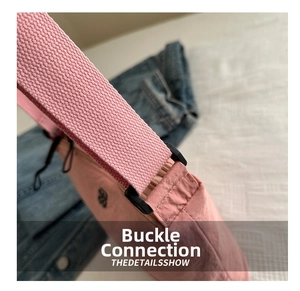 Detailed close-up of pink nylon bag connection with durable black plastic ring and strap