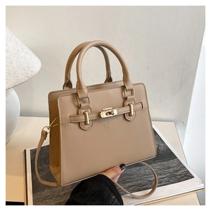 Close-up of the beige Kelly style handbag with golden turn-lock and premium PU leather texture